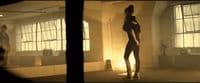 a woman standing in a room next to a window