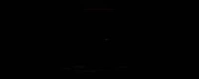 a dark room with a clock on the wall