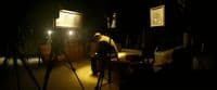 a man is standing in a dark room