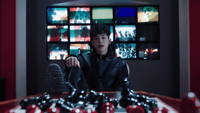 a man sitting at a table in front of a television