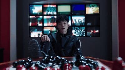 a man sitting at a table in front of a television