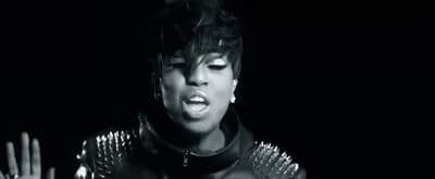 a woman in a leather jacket holding a microphone