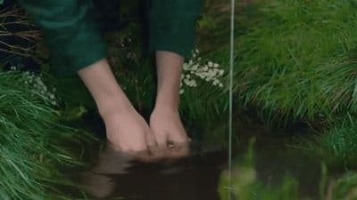 a person's feet in a puddle of water