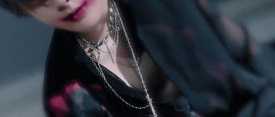 a woman with a black shirt and a chain around her neck