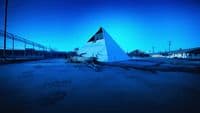 a large white pyramid sitting in the middle of a parking lot