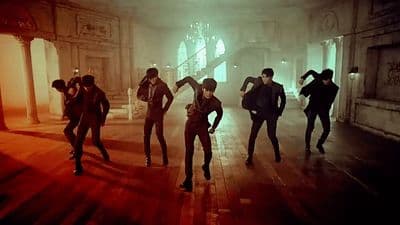 a group of people dancing in a dark room