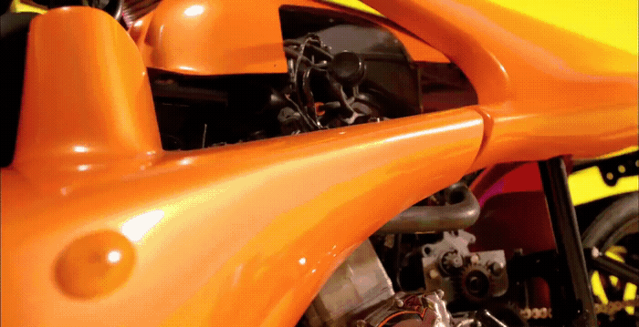 a close up of an orange motorcycle engine