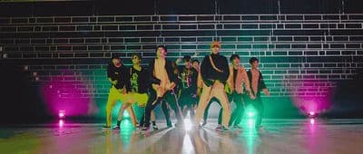 a group of people standing on top of a dance floor