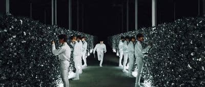 a group of men walking down a runway