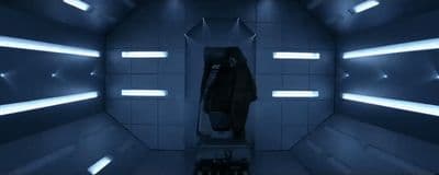 a man standing in a room with lights on