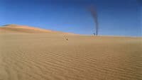 a person standing in the middle of a desert