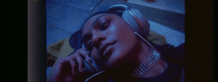 a woman talking on a cell phone while wearing headphones