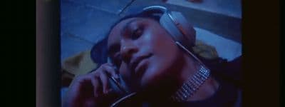 a woman talking on a cell phone while wearing headphones