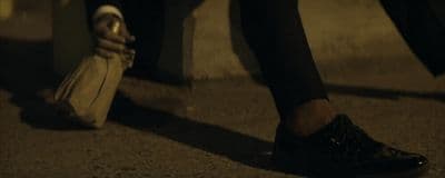 a person walking down a street with a bag