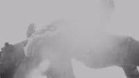 a man riding a snowboard down a snow covered slope