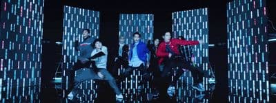 a group of people standing around each other