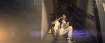 a man sitting on a step talking on a cell phone
