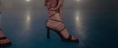 a pair of women's high heeled sandals on a blue floor