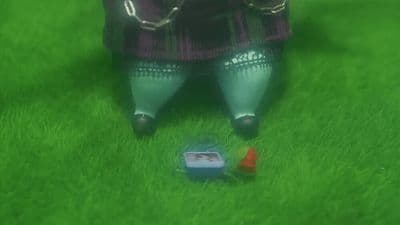 a person standing in the grass with a frisbee