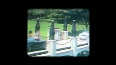 a blurry picture of people sitting on a dock