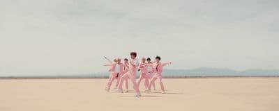 a group of people standing in the middle of a desert