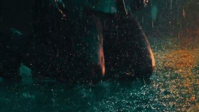 a person standing in the rain with an umbrella