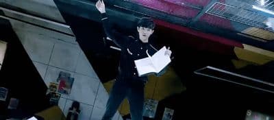 a man standing on top of a skateboard under a bridge
