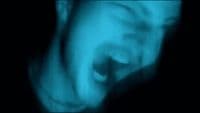 a blurry image of a person with their mouth open