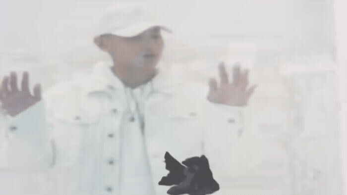 a blurry photo of a man with his hands up