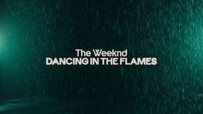 a green wall with the words dancing in the flames