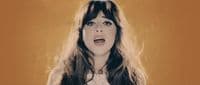 a woman with long hair is making a surprised face