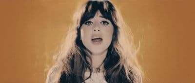 a woman with long hair is making a surprised face