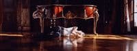 a person laying on the floor in front of a piano