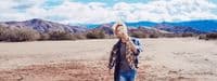 a man standing in the middle of a desert