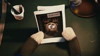 a person holding up a picture of a monkey