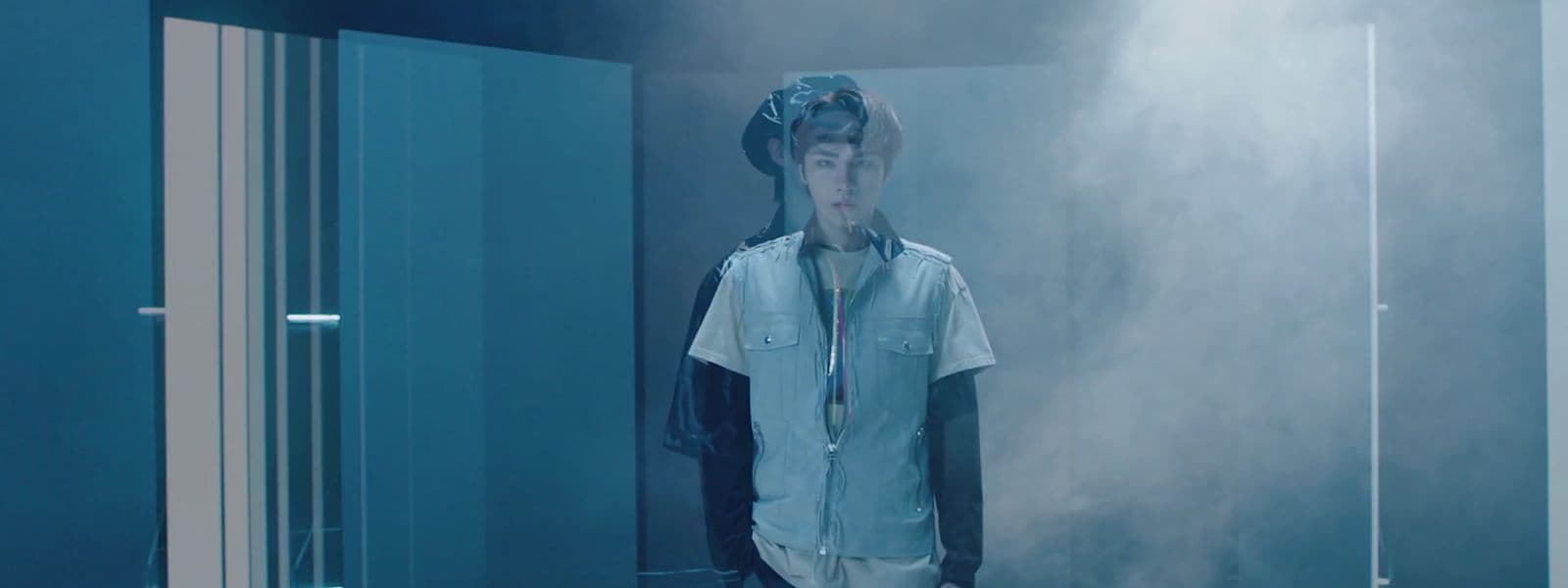 a man standing in front of a mirror in a room
