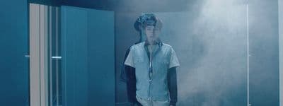 a man standing in front of a mirror in a room