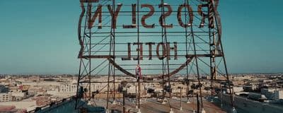 a large metal sign on top of a building