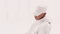 a person wearing a white hat and jacket