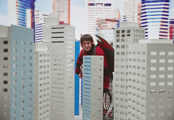 a man standing in front of a model of a city