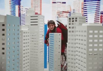 a man standing in front of a model of a city