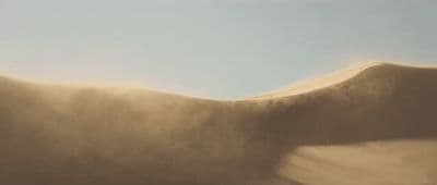 a blurry photo of a person's hand holding a surfboard