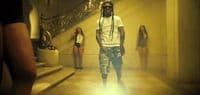 a man with dreadlocks standing in a hallway