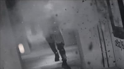 a man walking down a street next to a tall building