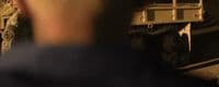 a blurry photo of a man standing next to a train