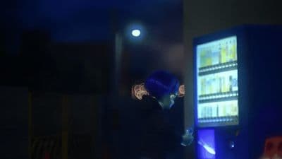 a man standing in front of a vending machine