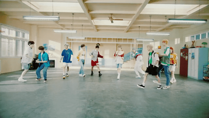a group of people walking around in a room