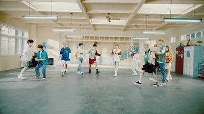 a group of people walking around in a room