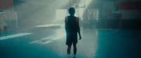 a person standing in a room with a blue floor