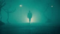 a person standing in the dark in the rain